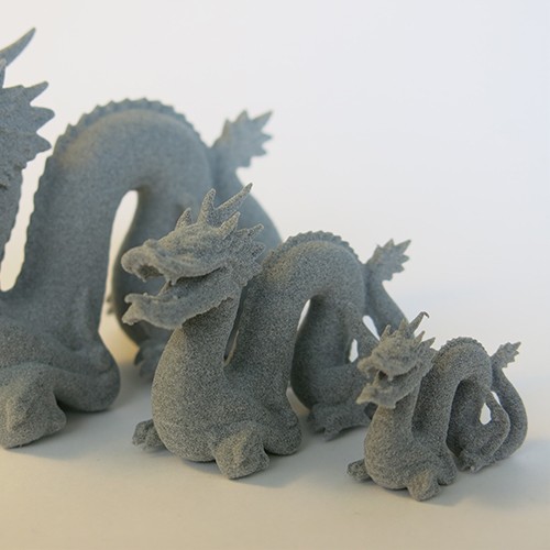 3D printed dragons in grey plastic with SLS technology