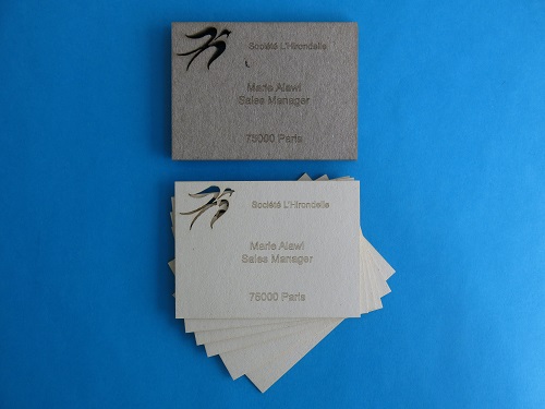 Some laser cut business card in cardboard