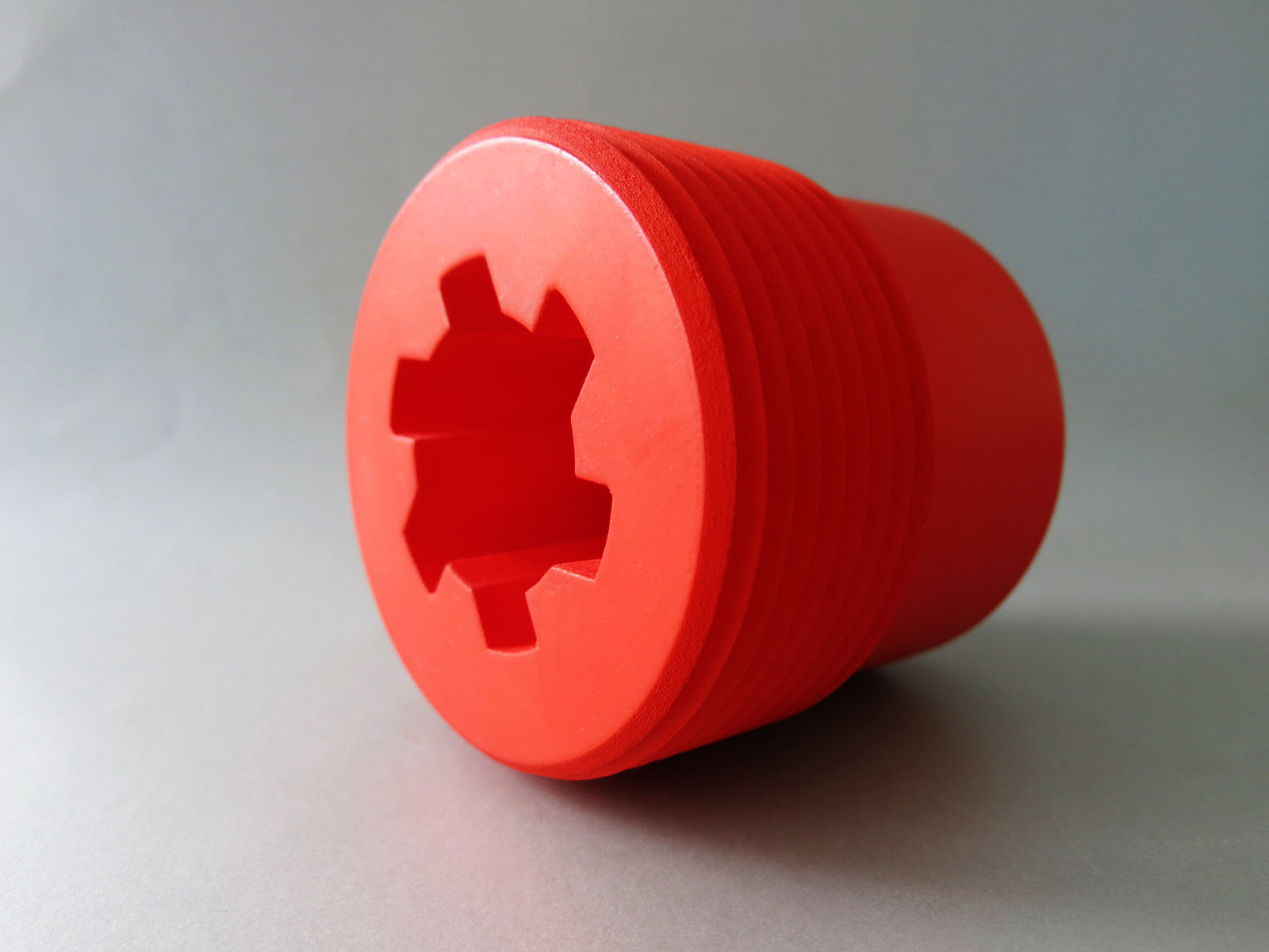 Set of 3D printed objects in black, translucent red and transparent resin